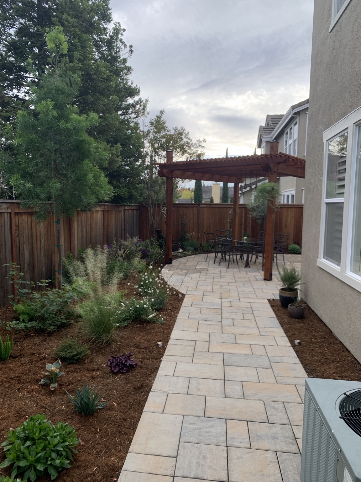 RJ Landscape completed a redwood pergola, paver patio and landscaped garden